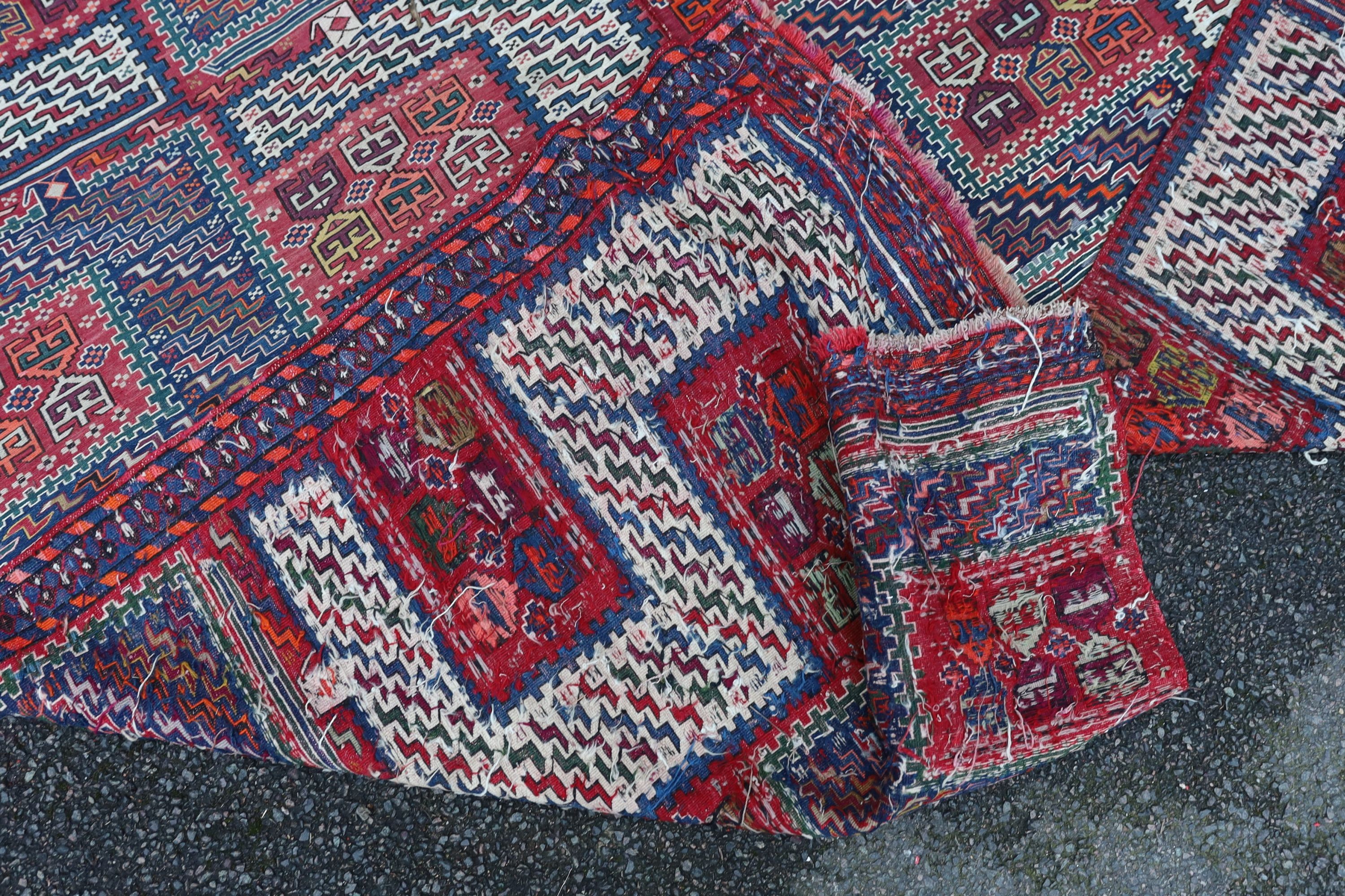 A Sumak weave 2-sectional carpet, combined dimension - 320 x 230cm.